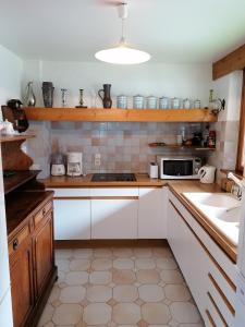 a kitchen with white cabinets and a sink at Chalet Erminea in Chamonix-Mont-Blanc