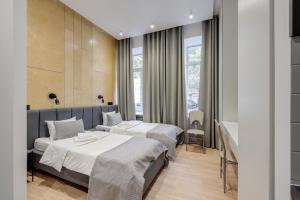 a hotel room with two beds and a window at Centrooms Kropivnizkogo Mini-Hotel in Kyiv