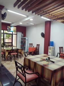 jadalnia ze stołami i krzesłami oraz telewizorem w obiekcie Hotel Israel - Lago Agrio w Nueva Loja