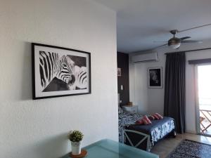 a living room with a zebra picture on the wall at VV Paraíso Del Sur in Playa Paraiso +51 photos