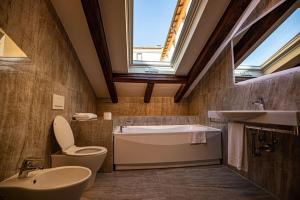 a bathroom with a sink toilet and a bath tub at Appartamento Palazzo Bocchi in Bologna