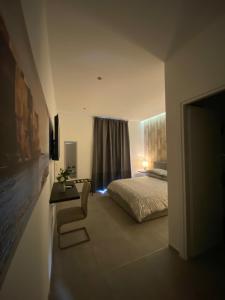 a bedroom with a bed and a television in it at Mamì B&B in Naples