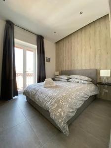 a bedroom with a large bed and a window at Mamì B&B in Naples