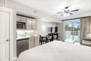 a kitchen and living room with a bed and a table at The Grand 2311 in Destin