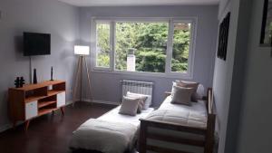 a bedroom with two beds and a window at Departamento Centrico en Bariloche Iß in San Carlos de Bariloche