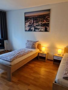 a bedroom with a bed and two tables with lamps at Monteurwohnung Mockau in Leipzig