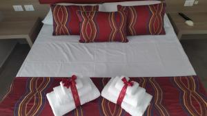 a bed with white towels and red bows on it at Regina Margherita Suite in Naples