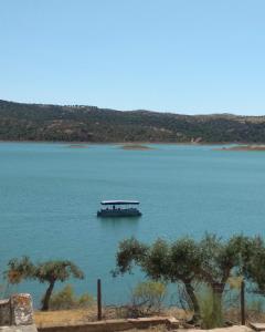 a boat in the middle of a large lake at Herdade Monte da Tapada in Alqueva