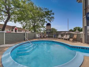 a large swimming pool with chairs and a table at 103 Pointes North Inn in Charlevoix