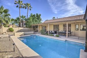 a swimming pool in front of a house at Upscale Home with Pool Less Than 5 Mi to TPC Scottsdale! in Phoenix