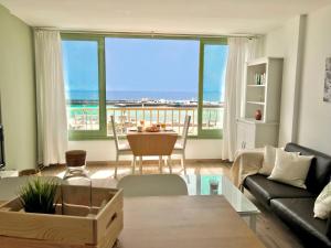 a living room with a view of the ocean at Apartamento Luna in Arrecife +2 photos