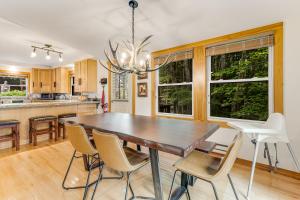 a dining room with a wooden table and chairs at Bee & Bae Hideaway in Beech Mountain