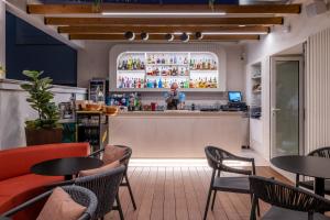 a bar in a restaurant with a man standing behind the bar at Soho Boutique Equitativa in Málaga