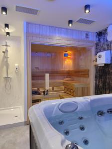 a large bathroom with a tub and a shower at Joy 5 Hotel & SPA in Belgrade