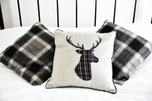 a bed with pillows with a deer applique on it at 6 Bryn Terrace, Conwy in Conwy