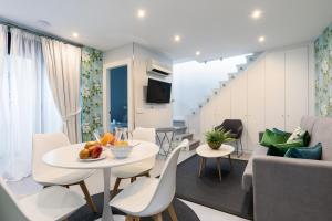 a living room and dining room with a table and chairs at Feelathome San Marcos Apartments in Madrid