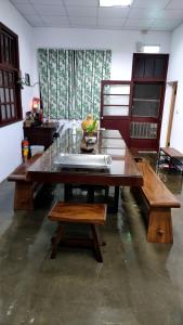 a living room with a wooden table and benches at 北斗合法古厝民宿 in Beidou +19 photos