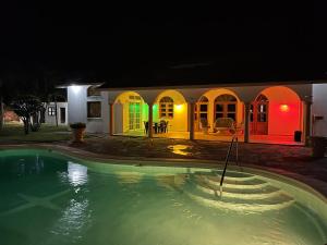 a house with a swimming pool at night at Ocean Breeze Villa Carismar in Cabrera
