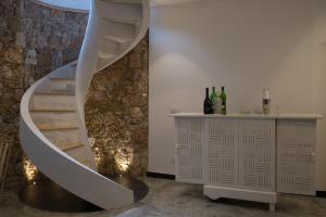 a spiral staircase in a room with a counter and wine bottles at ROSAMIMAMA citra OO9042-LT-0250 in Voze