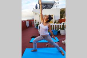 a woman doing a yoga pose on a yoga mat at Habanitas in Santa Cruz de la Palma