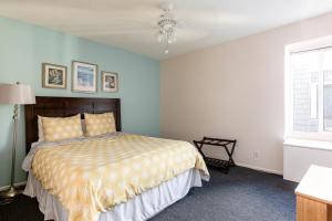 a bedroom with a bed and a ceiling fan at 3 Bedroom! - Complex is on the beach with huge pool in Oceanside