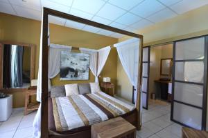 Postel nebo postele na pokoji v ubytování Hotel Ylang Ylang