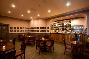 a restaurant with tables and chairs and a bar at Penybryn in Llandeilo