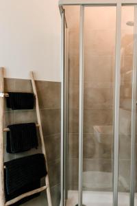 a shower with a glass door and some towels at Little Loft Limburg in Limburg an der Lahn