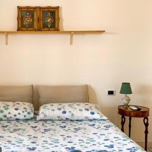 a bedroom with a bed and a table with a lamp at Villa La Serenata di Pietro in Taranto