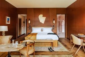 a bedroom with a bed and a table and chairs at Hôtel Madame Rêve in Paris