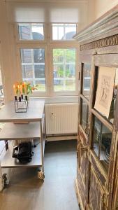 a room with a table and a large window at Hygge Living - Heart of Copenhagen in Copenhagen