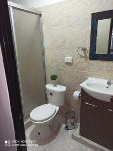 a bathroom with a toilet and a sink at Casa Azul Pinar del Rio San Agustín in San Agustín