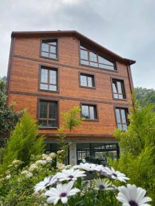 a brick building with windows and flowers in front of it at River Didi Otel in Rize