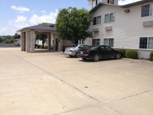 two cars parked in a parking lot in front of a building at Hunter Lodge in Ripley