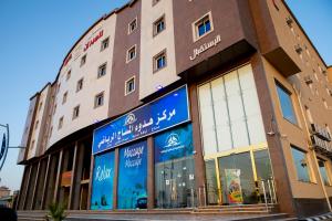 a store front of a building with signs on it at فندق لامير إن Lamer in Hotel in Sharurah