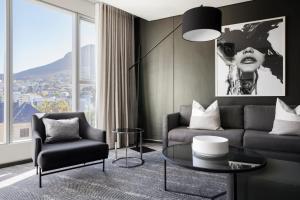 a living room with a couch and a table at The Capital 15 on Orange Hotel & Spa in Cape Town
