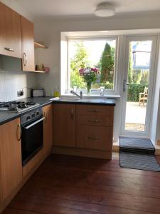 a kitchen with a sink and a window at ACE Largs Ground Floor Apartment with Garden in Largs