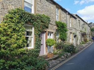 a row of stone houses on a street at End Cottage in Skipton