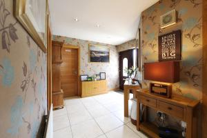 a hallway with a bathroom with a sink and a desk at Cloyfin B and B in Coleraine