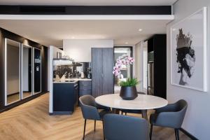 a kitchen and dining room with a table and chairs at The Capital 15 on Orange Hotel & Spa in Cape Town