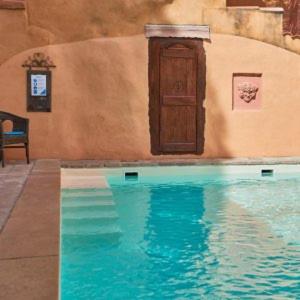 a painting of a door and a swimming pool at Les Arcades Le Lion D'or in Buis-les-Baronnies
