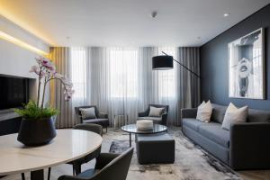a living room with a couch and a table at The Capital 15 on Orange Hotel & Spa in Cape Town