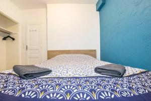 - un lit avec 2 oreillers dans une chambre dans l'établissement L'ESCALE - TOPDESTINATION-BOURG - Centre ville - Classé 3 étoiles, à Bourg-en-Bresse