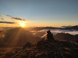 a sunset on the top of a mountain with clouds at APARTAMENTO VALMAYOR in Potes +5 photos