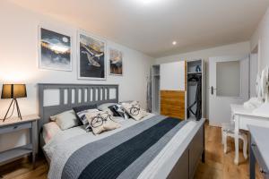 a bedroom with a large bed with pillows at Flora Apartment Kosice Center in Košice
