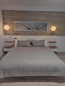 a large white bed in a bedroom with two lights at Marko de Luxe in Ivano-Frankivsʼk
