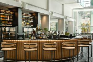 a bar at a restaurant with stools at The Capital 15 on Orange Hotel & Spa in Cape Town