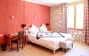 a red bedroom with a bed and a desk and a table at Les Arcades Le Lion D'or in Buis-les-Baronnies
