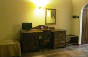 a room with a desk with a computer and a mirror at Hotel Tenuta San Francesco in Barletta