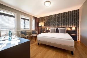 a hotel room with a bed and a desk at Landgasthof Kranz in Ohlsbach